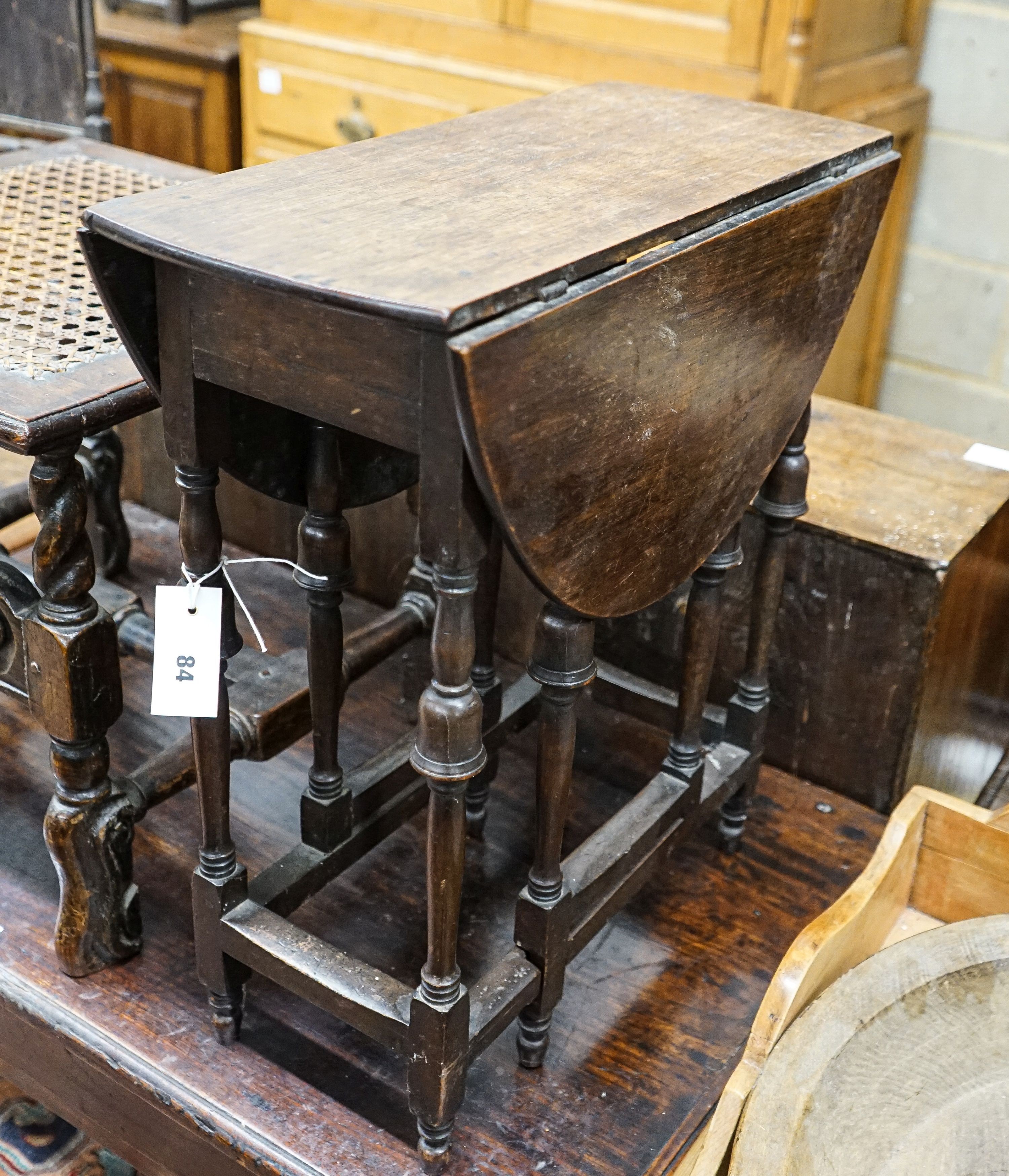 An unusually small late 17th century style mahogany gateleg table, with oval top and inverted cup turned legs, 65cm extended, depth 57cm, height 55cm